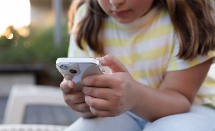 Young child holding a cellphone 